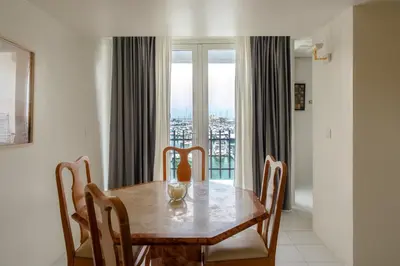 a dining room with a wooden table and chairs at Marina Views in Quarteira