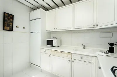a bedroom with a bed and a couch and a window at Marina Views in Quarteira