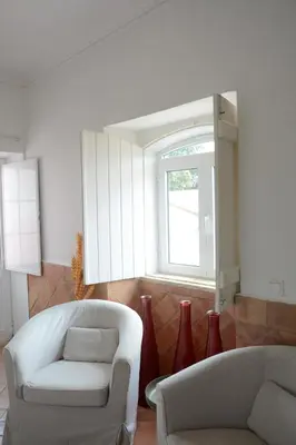 a bedroom with a bed with a hat on it at SOLAR DOS AVÓS in Guia