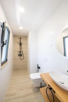 a bathroom with a white toilet and a sink at Atlantis Luxury Villa by Atlantic Places in Albufeira