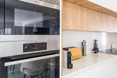 a kitchen with a stainless steel oven and cabinets at Atlantis Luxury Villa by Atlantic Places in Albufeira