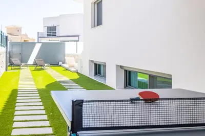 a tennis court on the roof of a building at Atlantis Luxury Villa by Atlantic Places in Albufeira