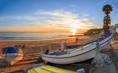 a group of boats on the beach at sunset at Casa Salty in Albufeira