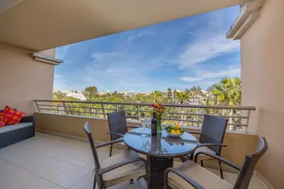 a balcony with a table and chairs with a view at Algarve Beach Apartments in Albufeira