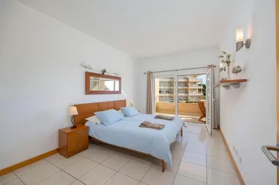 a bedroom with a bed with two towels on it at Algarve Beach Apartments in Albufeira