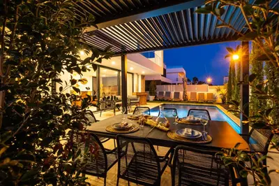 a table with plates of food on top of a patio at Villa kambolé in Albufeira