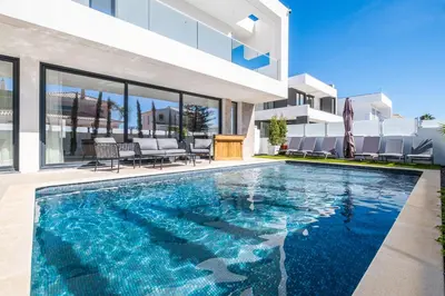 a swimming pool in the backyard of a house at Villa kambolé in Albufeira