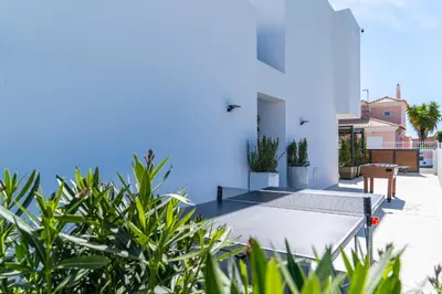 a view of a house with blue walls and plants at Villa kambolé in Albufeira