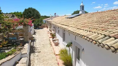 a view of a building with a tile roof at Vila Lobo Algarve in Faro