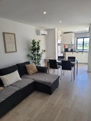 a living room with a couch and a dining room at Apartamento T1 Salgados in Guia
