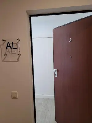 a door in a room with a sign on the wall at Apartamento T1 Salgados in Guia