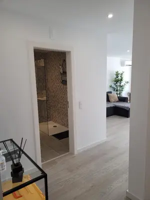 a living room with white walls and a glass table at Apartamento T1 Salgados in Guia