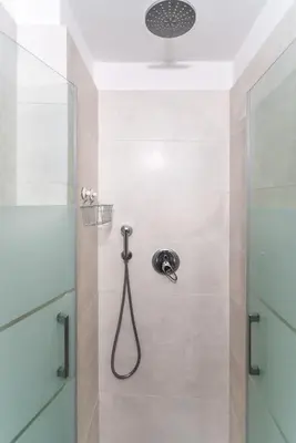 a shower with a shower head in a bathroom at Faro Center Stunning View in Faro