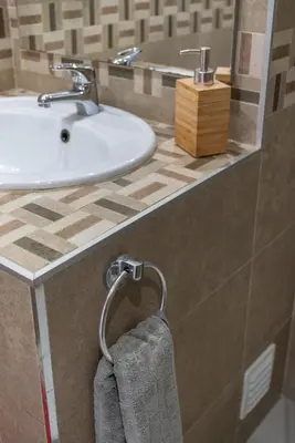 a bathroom with a sink and a towel at Faro Center Stunning View in Faro