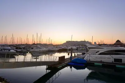 a group of boats docked in a marina at sunset at Villa Cove - Villa in complex only 5 minutes from the Marina of Vilamoura in Quarteira