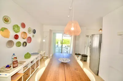 a kitchen with a wooden table in a room at Villa Cove - Villa in complex only 5 minutes from the Marina of Vilamoura in Quarteira