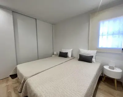 a bedroom with two twin beds and a window at Miral 4 - 100 mtr to beach by HD PROPERTIES in Quarteira