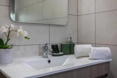 a white sink in a bathroom with a mirror at Centralgarve - Elegant and Cosy Studio in the Heart of Vilamoura - Aldeia do Mar T0 in Vilamoura