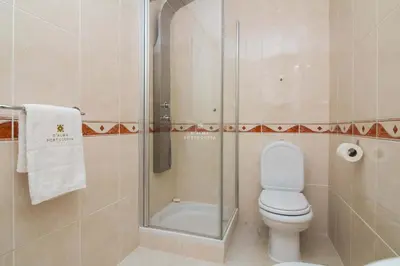 a bathroom with a toilet and a shower at Vilamoura Apartment Jacaranda - By Dalma Portuguesa in Vilamoura