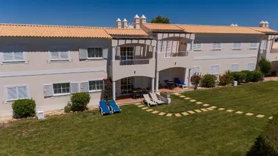 an aerial view of a large building with a yard at Apartamento no Condomínio Baia Village com Piscina in Albufeira
