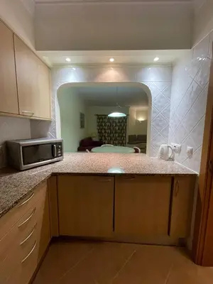 a kitchen with a microwave and a mirror in a room at Lovely 2 Bedroom Home inside a Resort in Albufeira in Albufeira