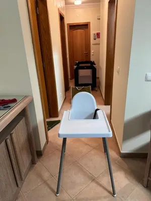 a white chair in a hallway with a room at Lovely 2 Bedroom Home inside a Resort in Albufeira in Albufeira