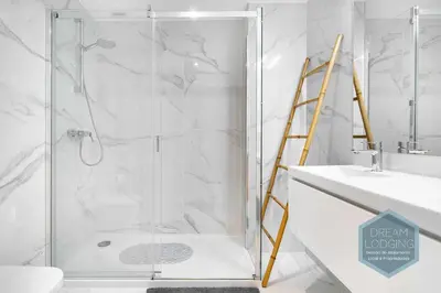 a shower with a glass door in a bathroom at Albufeira Prime 1B - Dream Lodging in Albufeira