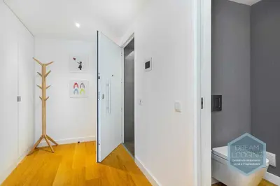 a hallway with a glass door and a mirror at Albufeira Prime 1B - Dream Lodging in Albufeira