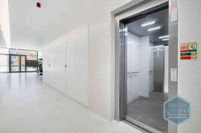 a hallway with a glass door in a building at Albufeira Prime 1B - Dream Lodging in Albufeira