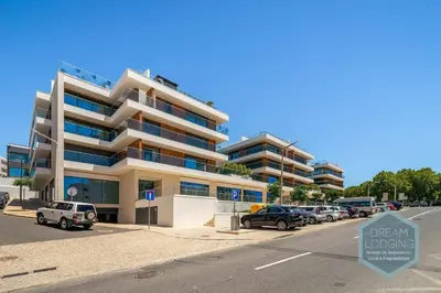 a parking lot with cars parked in front of a building at Albufeira Prime 1B - Dream Lodging in Albufeira