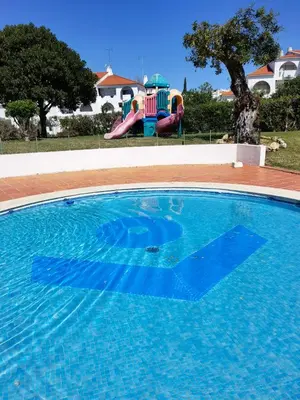 a large swimming pool with a water slide at 209 Modern Apartment in central Albufeira close to everything in Albufeira