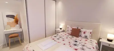 a small bedroom with a bed and a chair at 209 Modern Apartment in central Albufeira close to everything in Albufeira