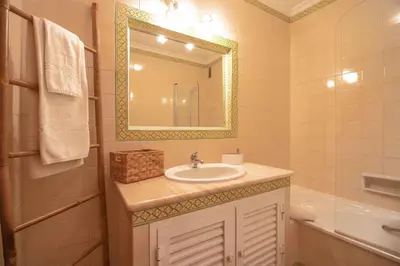 a bathroom with a sink and a mirror at Apartamento Varandas do Sol in Vilamoura