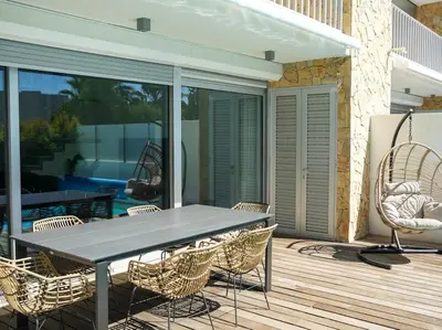 a patio with a table and chairs on a deck at Harmony 4I House by Stay ici Algarve Holiday Rental in Albufeira