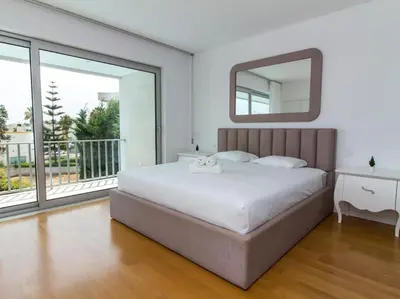 a bedroom with a large bed and a mirror at Harmony 4I House by Stay ici Algarve Holiday Rental in Albufeira