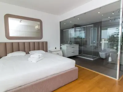 a bedroom with a large white bed and a bathroom at Harmony 4I House by Stay ici Algarve Holiday Rental in Albufeira