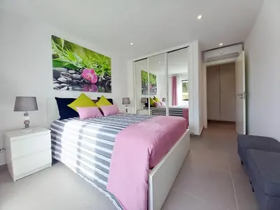 a kitchen with gray cabinets and a microwave at T2 Tenis Golf Mar in Vilamoura