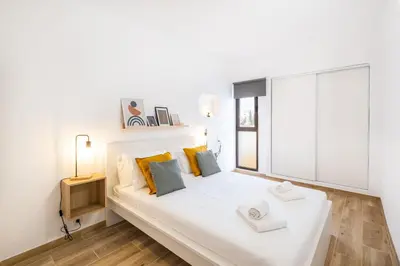 a white bed in a room with a large window at #011 T1 Libertos by Home Holidays in Albufeira