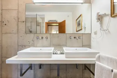 a bathroom with two sinks and a mirror at Vila Santa Eulália in Albufeira