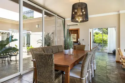 a dining room with a wooden table and chairs at Vila Santa Eulália in Albufeira