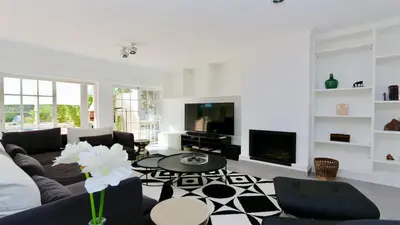 a living room with a couch and a table at Vila Castro-Cleverdetails, Quiet area, private pool in Vilamoura