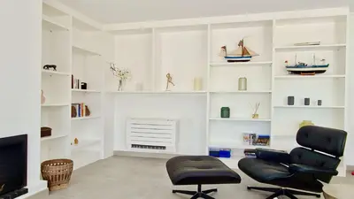 a living room with two chairs and a fireplace at Vila Castro-Cleverdetails, Quiet area, private pool in Vilamoura