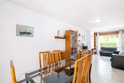 a dining room and living room with a glass table at #047 Families Only - Almond Tree by Home Holidays in Albufeira