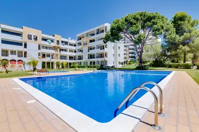 a swimming pool in front of a apartment building at Topazio - Pool & near the center by HD PROPERTIES in Vilamoura