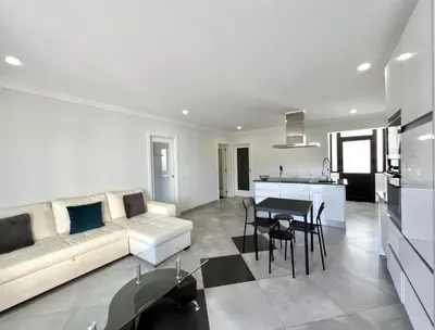 a living room with a couch and a table at Topazio - Pool & near the center by HD PROPERTIES in Vilamoura