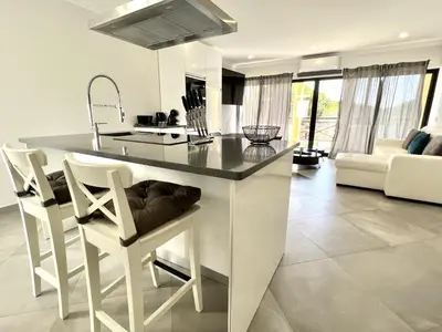 a kitchen with a large white island in a room at Topazio - Pool & near the center by HD PROPERTIES in Vilamoura