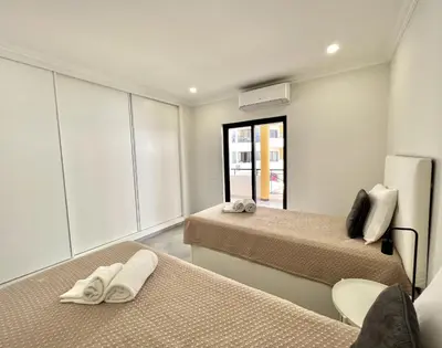 a room with two beds and a window at Topazio - Pool & near the center by HD PROPERTIES in Vilamoura
