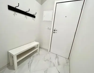 a white bathroom with a white door and a bench at Aman - Near the beach by HD PROPERTIES in Quarteira