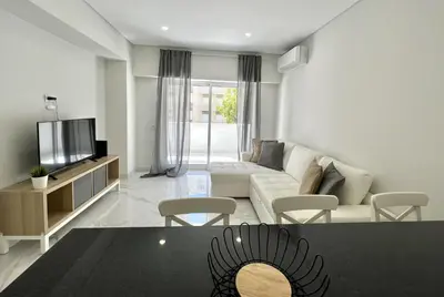 a living room with a couch and a tv at Aman - Near the beach by HD PROPERTIES in Quarteira