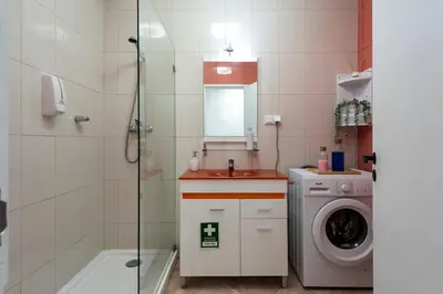 a bathroom with a shower and a washing machine at NUZZA - Vilamoura Marina with BBQ in Vilamoura